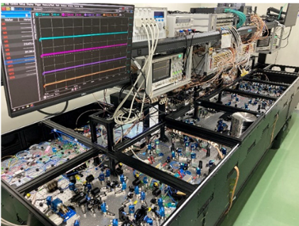 a complicated array of mirrors with a few computer over it.